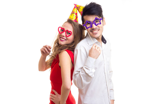 Young couple with card sticks and celebrating hats - Foto, afbeelding