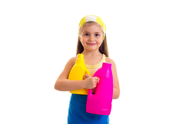 Girl in apron holding two bottles - Fotografie, Obrázek