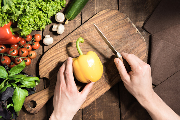 hands cutting pepper on chopping board  - Photo, Image