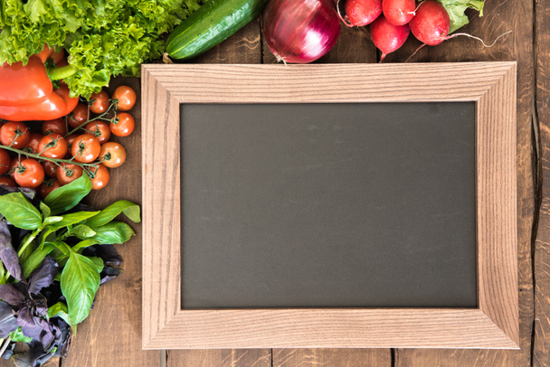 chalkboard with group of fresh vegetables  - Photo, Image