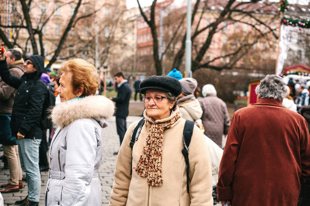 Prague, Czech Republic December 13, 2016 - the group of elderly tourists on sightseeing in the city centre in Prague - Fotoğraf, Görsel