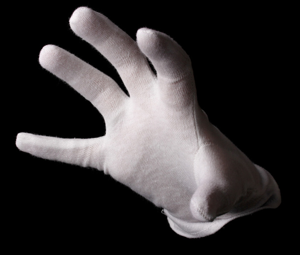 Hand in white glove making sign isolated on black - Foto, afbeelding