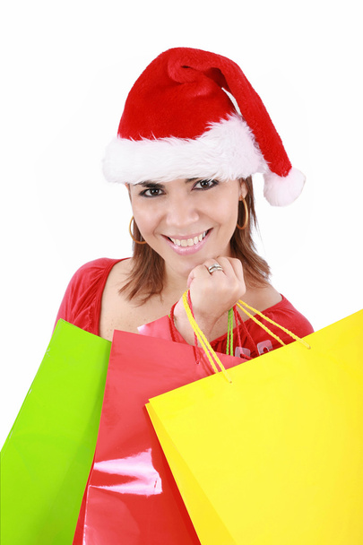 Donna felice in cappello Babbo Natale che tiene borse della spesa, sopra un bac bianco
 - Foto, immagini