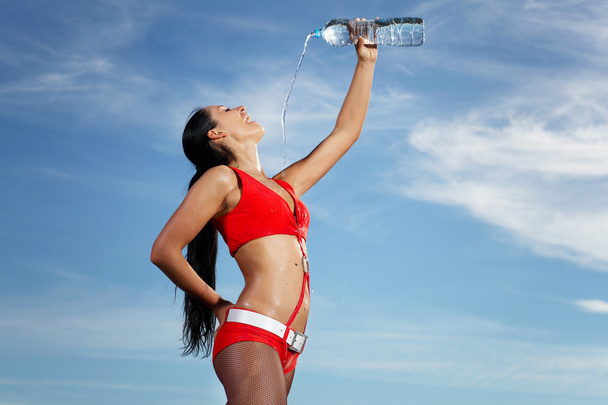 Young female sport girl with a bottle of water - Photo, Image