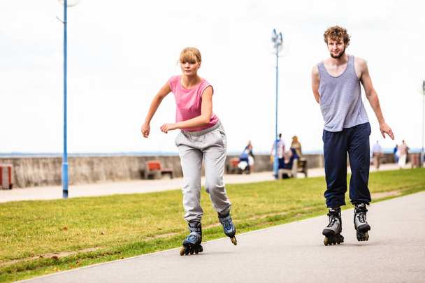 Two people race together riding rollerblades. - Foto, immagini