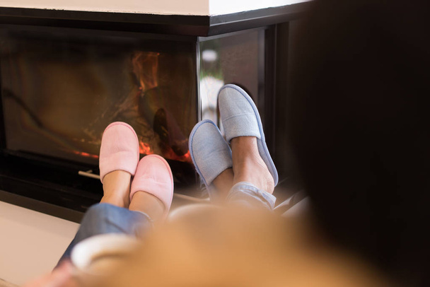 Young multiethnic couple  in front of fireplace - 写真・画像