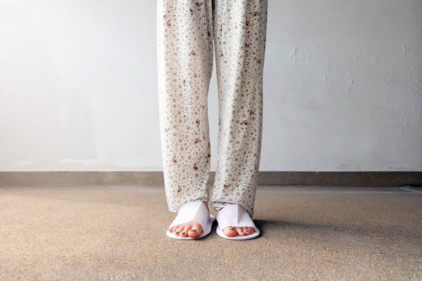 Closeup Photo of From Woman Feet Wearing White Slippers Indoor On The Ground  - Photo, Image