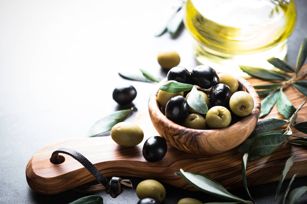 Black and green olives in wooden bowl - Photo, Image