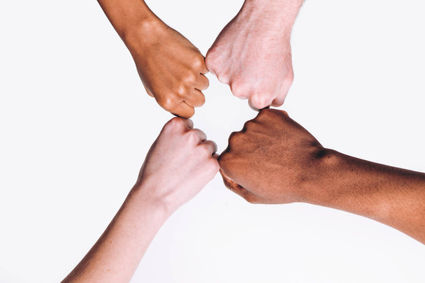Interracial friend, white and black hands together - Foto, imagen