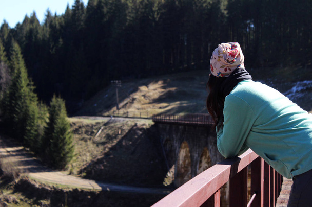 鉄道橋の上の孤独な少女。Vorokhta、ウクライナ - 写真・画像