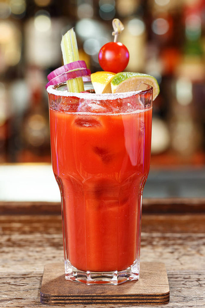 Bloody Mary garnished with cherry tomatoes and celery - Foto, afbeelding