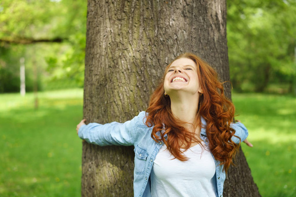 Ecstatic young woman grinning happily - Foto, Bild