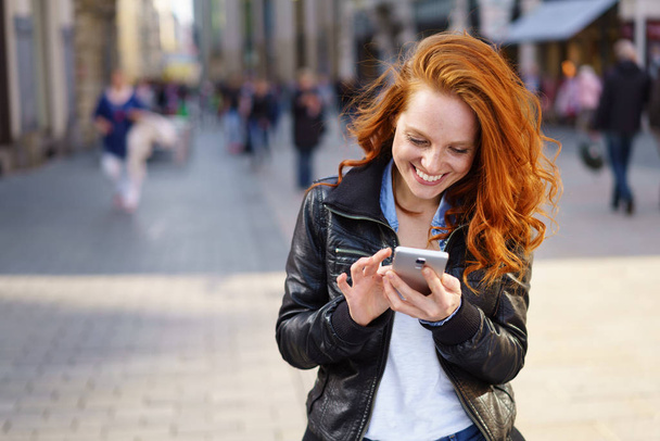 Relaxed happy woman texting on her mobile - Photo, Image