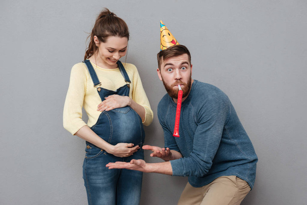 Portrait of a happy young family expecting child and celebrating - Foto, Imagen