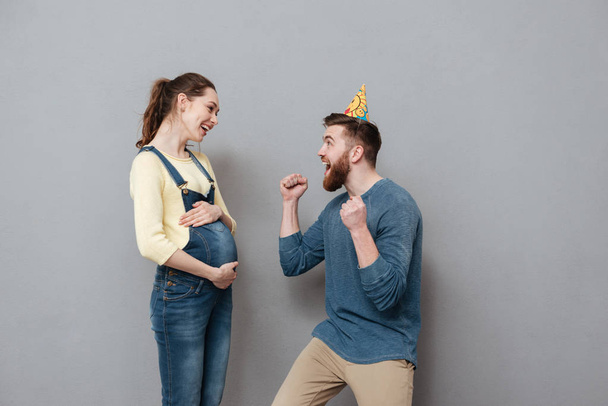 Portrait of a cheerful young couple celebrating pregnancy - Fotó, kép