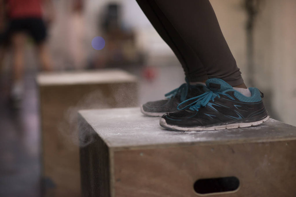black woman is performing box jumps at gym - Foto, Imagem