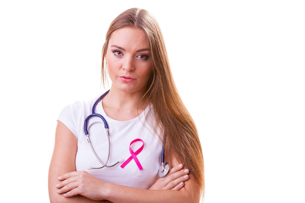 Woman with pink ribbon aids symbol and stethoscope on chest. - Fotó, kép