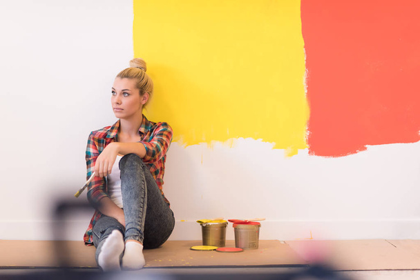 young female painter sitting on floor - Фото, изображение