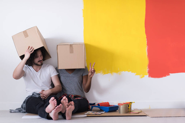young multiethnic couple playing with cardboard boxes - Fotó, kép