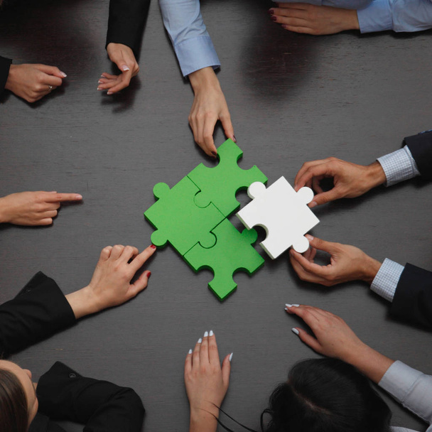 Business people assembling puzzle  - Fotó, kép