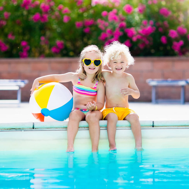 Kids playing at outdoor swimming pool - Photo, Image