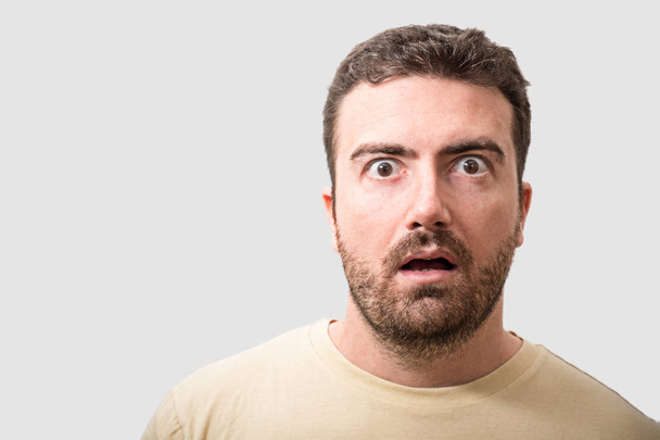 Head of surprised man portrait on gray background - Photo, Image