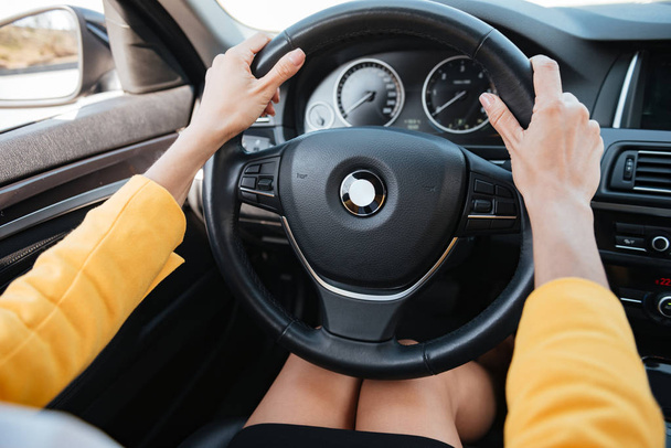 Hands holding car wheel and driving - Φωτογραφία, εικόνα