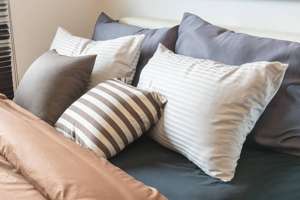 set of pillows on modern bed in modern bedroom  - Φωτογραφία, εικόνα