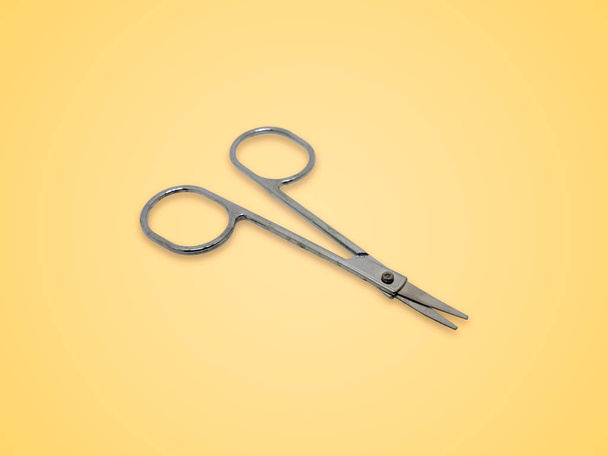 Dirty scissor nose hair skimmer isolated on yellow background. - Foto, immagini