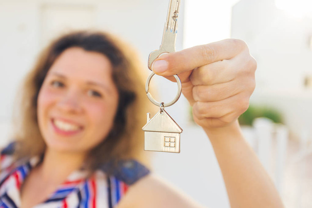 Close-up of happy house owner or renter showing keys and looking at you - Photo, Image