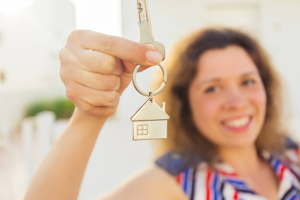 Close-up of happy house owner or renter showing keys and looking at you - Photo, Image