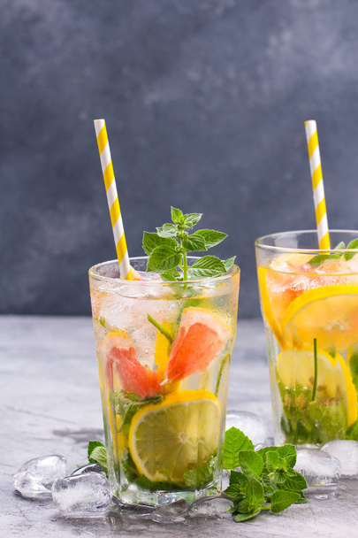 Cold refreshing summer lemonade in a glass on a grey concrete or stone background. - Фото, зображення