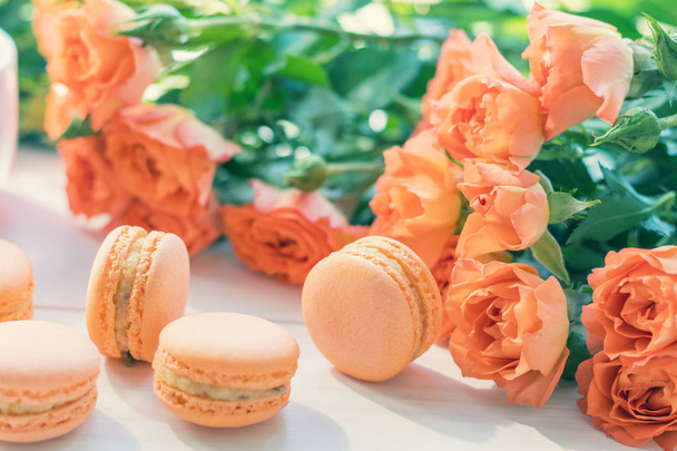 Orange macaroons and fresh little roses - Zdjęcie, obraz