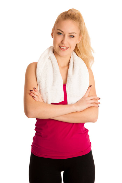 Woman resting after fitness workout with towel arounfd her neck  - Fotó, kép