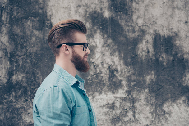 Side view of stylish red bearded nerdy in casual outfit outside. - Foto, afbeelding