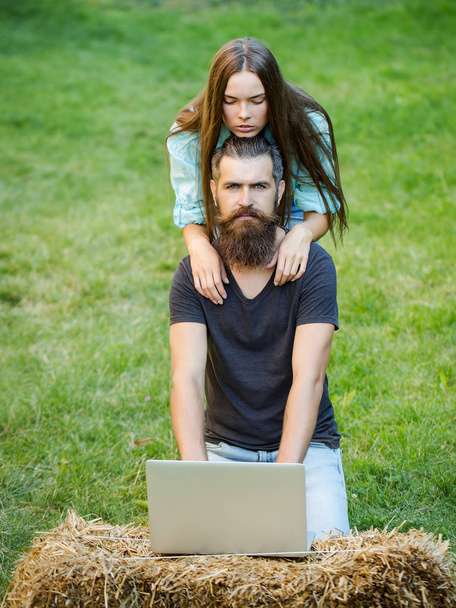 man and cute girl using laptop on nature - Fotoğraf, Görsel