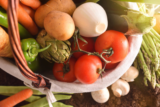 Vegetables in basket on soil top close up - Photo, Image