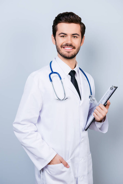Vertical portrait of successful happy smiling doctor in uniform  - Photo, Image