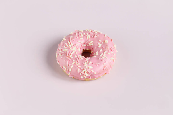 Pink donut on plain background - Fotó, kép
