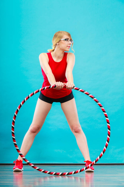 Fit woman with hula hoop doing exercise - Photo, image