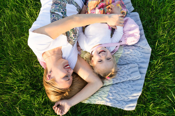 Happy family moments. Mother and daughter smiling at the park - 写真・画像