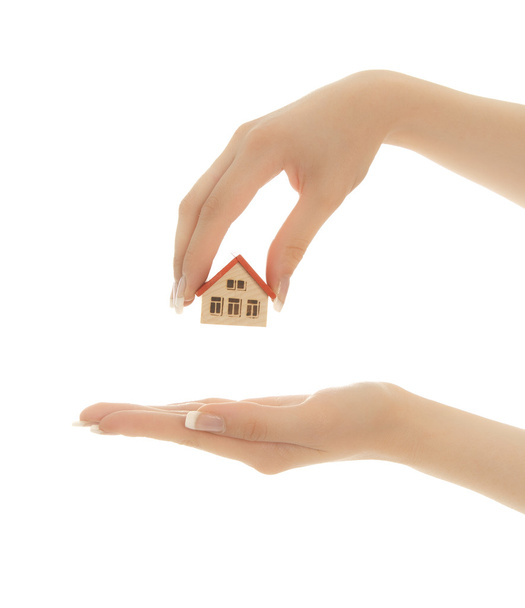 Woman's hands holding a toy house isolated on white - Photo, Image