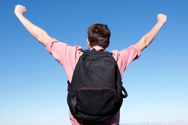 man with backpack with arms outstretched - Photo, image