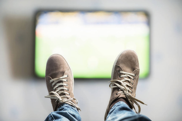 man Relaxing  near the TV - Photo, image