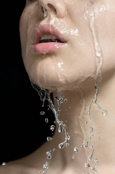 Water splashes on womans face - Foto, afbeelding