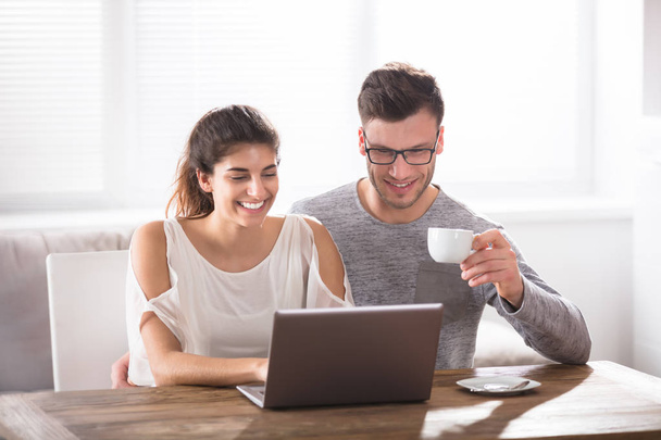 couple using laptop at home - Фото, изображение