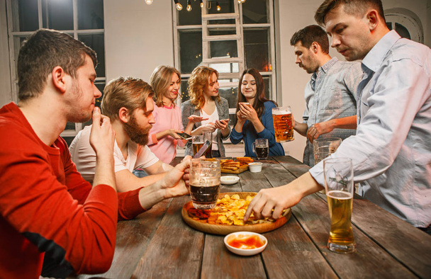 Group of friends enjoying evening drinks with beer - Фото, зображення