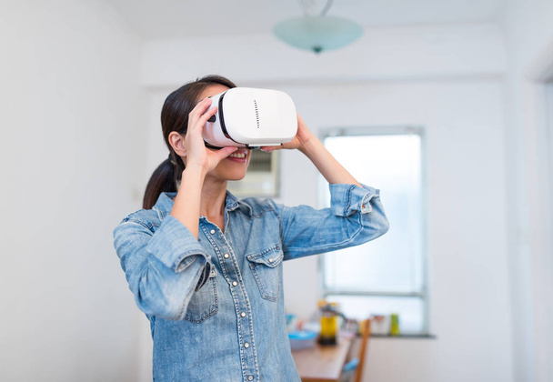 Woman looking with VR device - 写真・画像