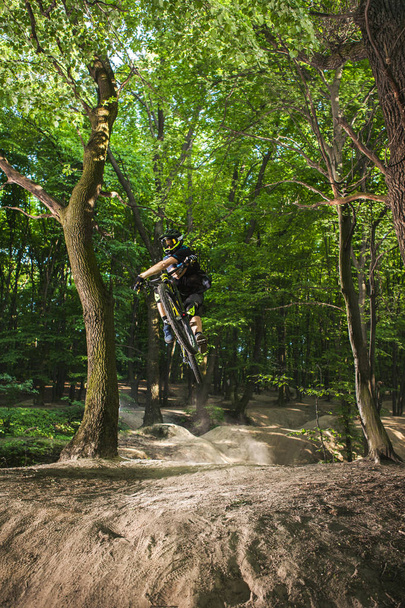 Man bikes in the green forest. - Foto, Bild