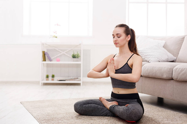 Yoga at home, woman do lotus pose - Foto, imagen